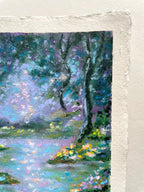 A close-up of a textured oil pastel painting featuring an impressionistic landscape with trees, water, and flowers in shades of blue, green, purple, and yellow.