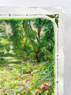 A close-up of an oil pastel painting on textured paper, depicting a lush green forest scene with trees, a rabbit and wildflowers, framed by a white border with decorative corner and side motifs.