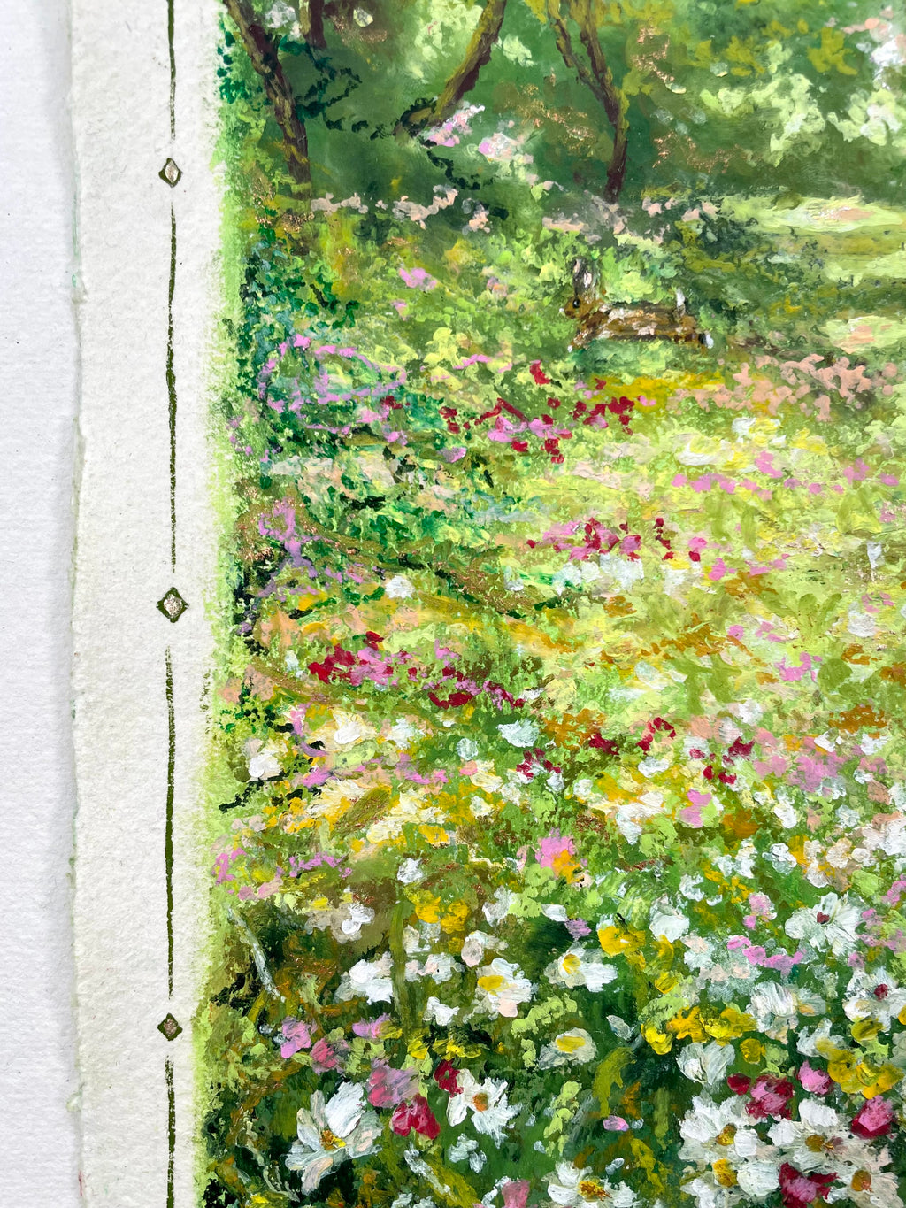 A close-up of an oil pastel painting depicting a lush green meadow filled with white, pink, and yellow wildflowers, with textured paper borders visible on the left side.