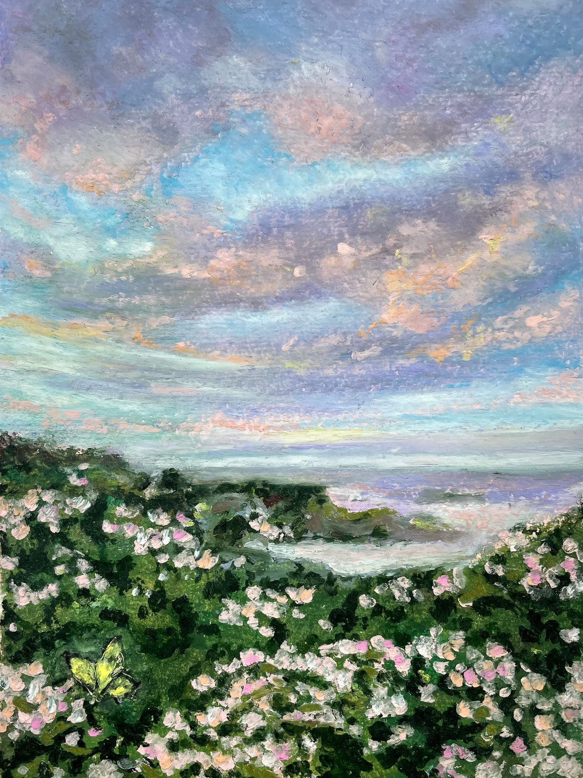 Impressionistic landscape painting of a coastal scene with a dramatic cloudy sky in shades of blue, purple, and pink, overlooking a shoreline with dense green foliage and pink and white flowers.