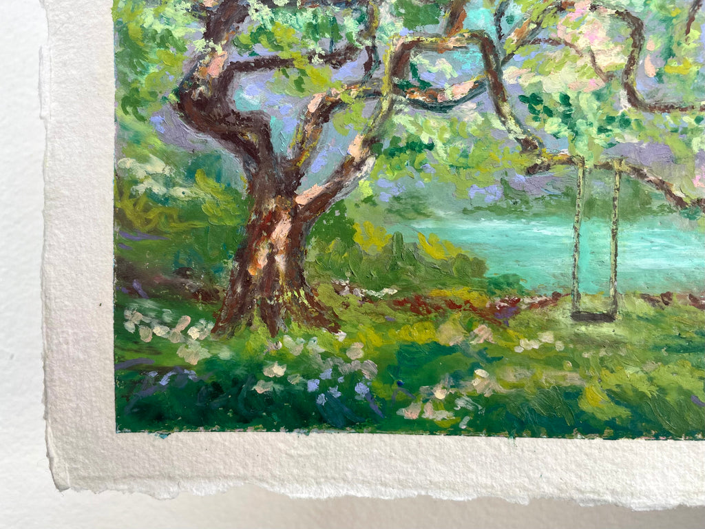 A close-up of an impressionistic landscape painting on textured paper, featuring a large gnarled tree with green foliage, a turquoise body of water, and a swing set in the background.
