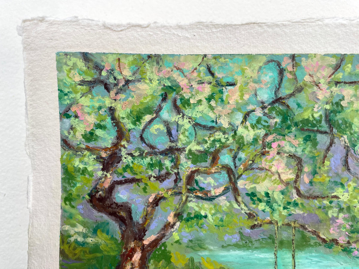 A close-up of an oil pastel painting on textured paper, depicting a tree with green and pink foliage, brown branches, and a turquoise background.