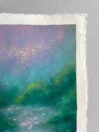 A close-up of a textured paper original painting featuring an impressionistic landscape with shades of teal, green, purple, and pink.