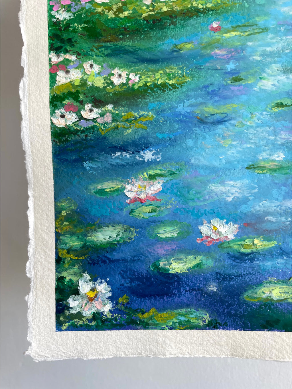 Textured close-up of lily pads and delicate water lilies in an original oil pastel pond landscape painting with vibrant deep blue water, impressionist oil pastel texture and peaceful nature details.