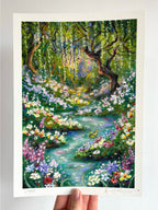 Limited edition giclée fine art print of whimsical oil pastel landscape “Looking for Wonderland,” featuring enchanted river, butterfly, wildflowers, and glowing weeping willow held against a white wall.