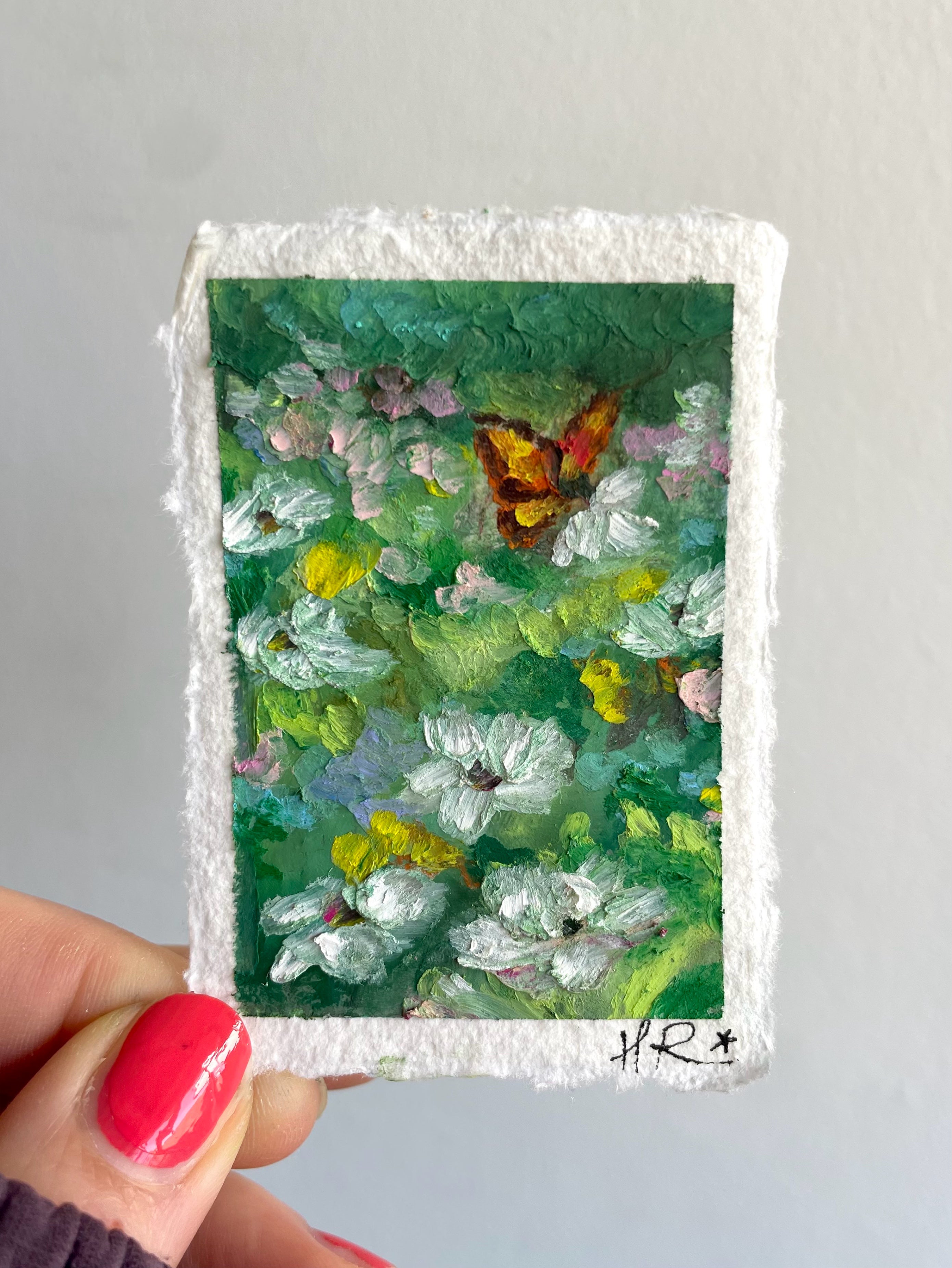 Miniature oil pastel butterfly painting featuring textured wildflowers, deep green meadow tones, and whimsical nature-inspired detail.