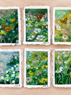 Gallery of six whimsical mini original oil pastel paintings on cotton rag paper featuring butterflies, flowers, ponds, and magical nature-inspired landscapes. 