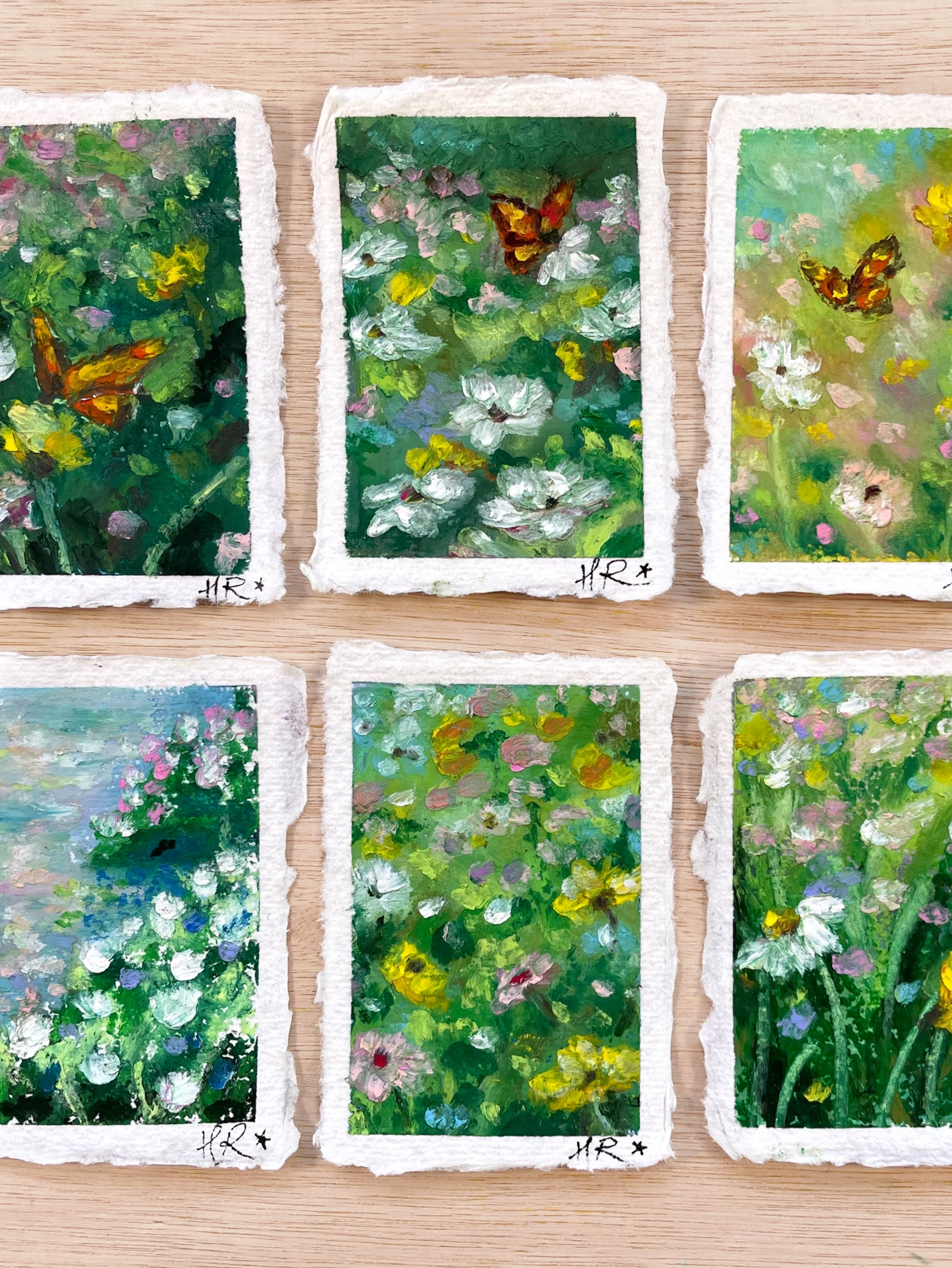 Gallery of six whimsical mini original oil pastel paintings on cotton rag paper featuring butterflies, flowers, ponds, and magical nature-inspired landscapes. 