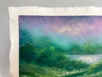 A close-up of a textured paper painting showing a landscape scene with green fields, a body of water, and a purple and teal sky.