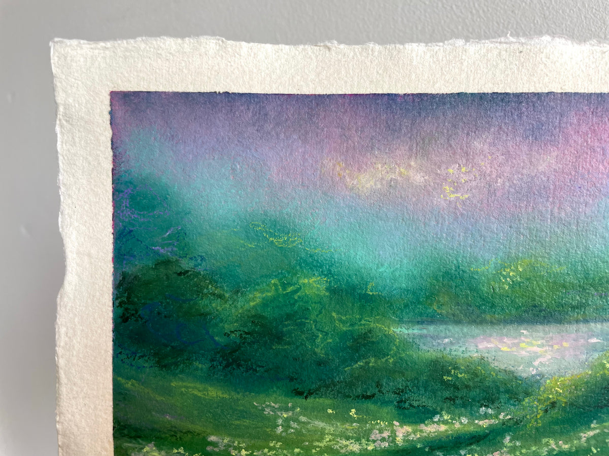 A close-up of a textured paper painting showing a landscape scene with green fields, a body of water, and a purple and teal sky.