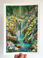 Limited edition giclée fine art print of magical fairytale forest landscape with waterfall, butterflies, wildflowers, and turquoise river held against a white wall.