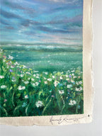 Detail of whimsical oil pastel wildflower landscape painting showing artist signature in the bottom right corner with textured paint surface.
