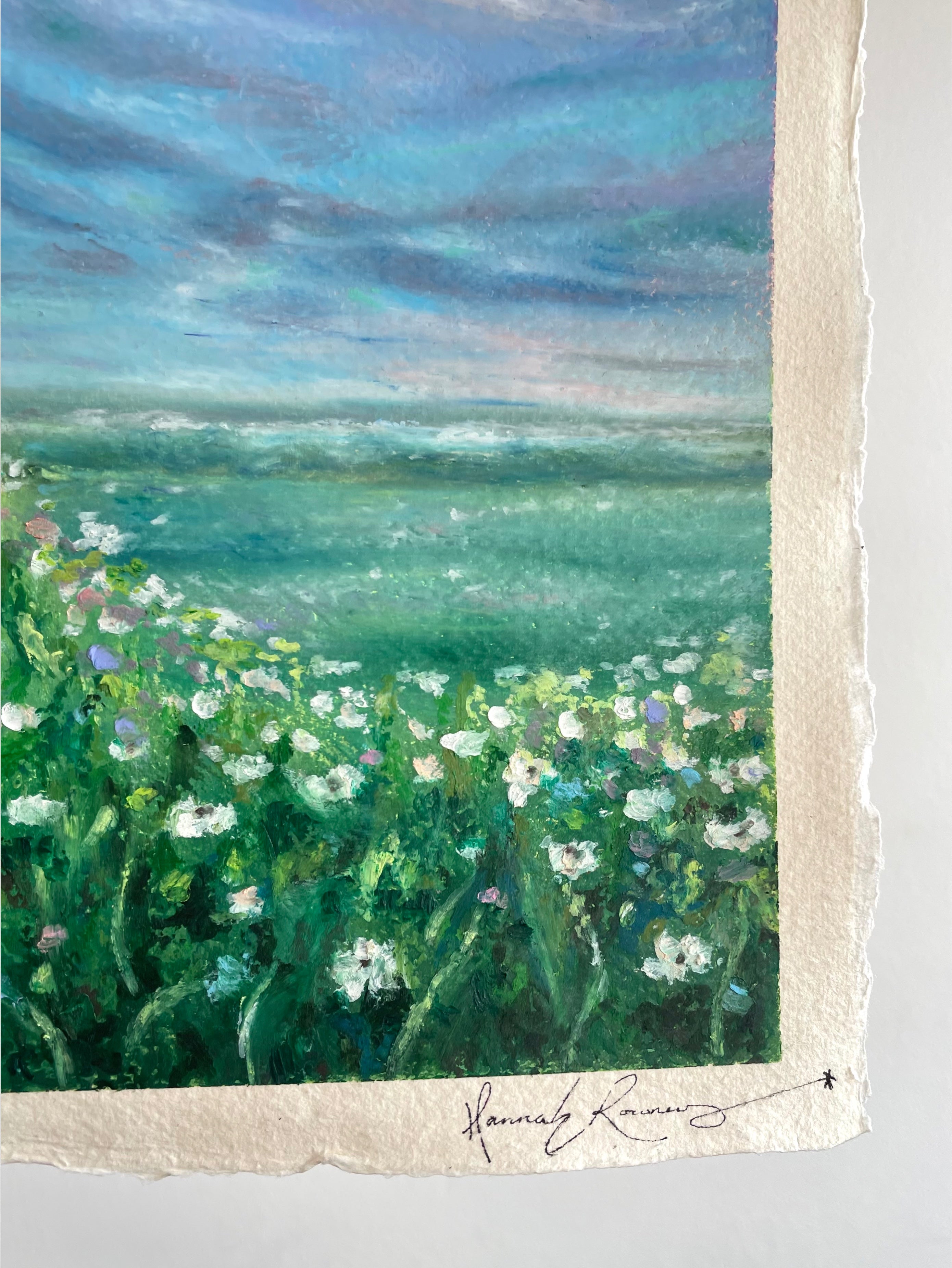 Detail of whimsical oil pastel wildflower landscape painting showing artist signature in the bottom right corner with textured paint surface.