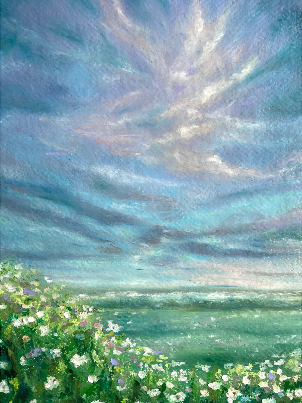 Cropped view of whimsical oil pastel painting showing wildflower meadow with expressive blue and purple sky and soft impressionist cloud forms.