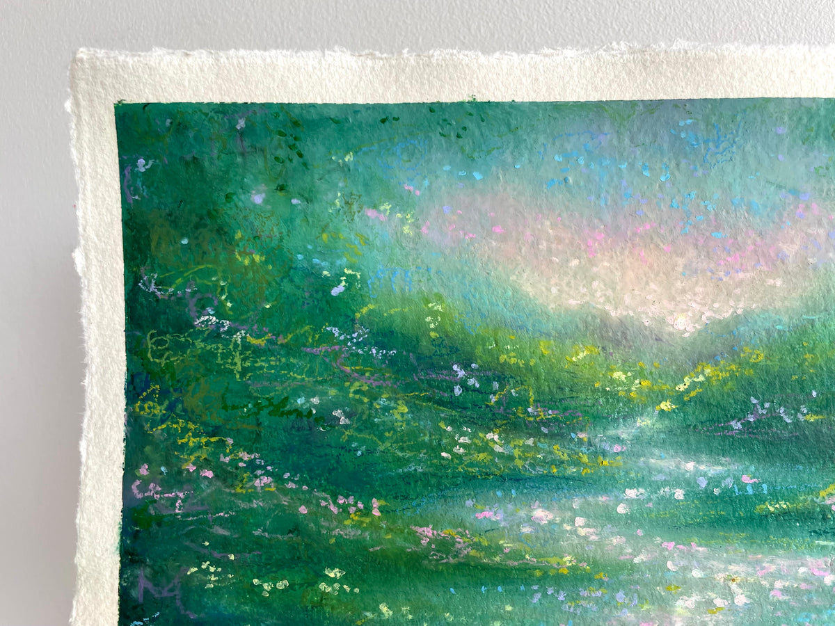 A close-up of a textured oil pastel painting on handmade paper, showing a landscape with shades of green, teal, and soft pink highlights.